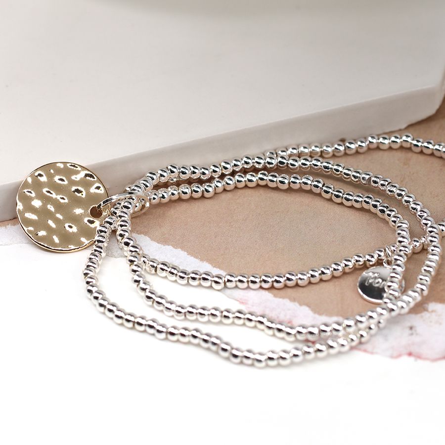 Silver plated triple strand bracelet with golden disc 03619