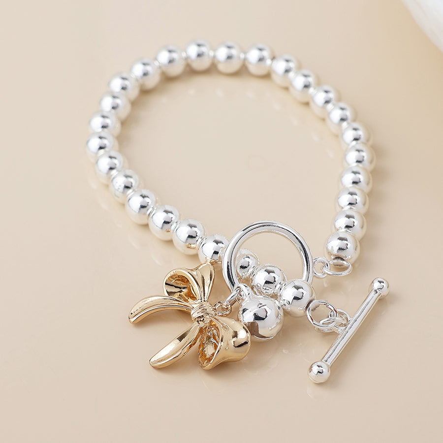 POM -Silver Plated Bell and Golden Bow Charm Bracelet