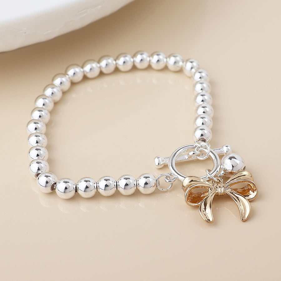 POM -Silver Plated Bell and Golden Bow Charm Bracelet